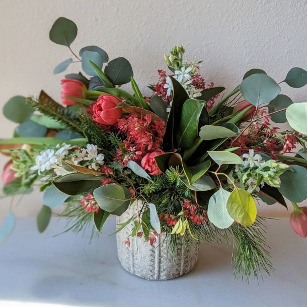 Heaven Scent floral arrangement with red tulips, eucalyptus and mixed blooms in a textured vase